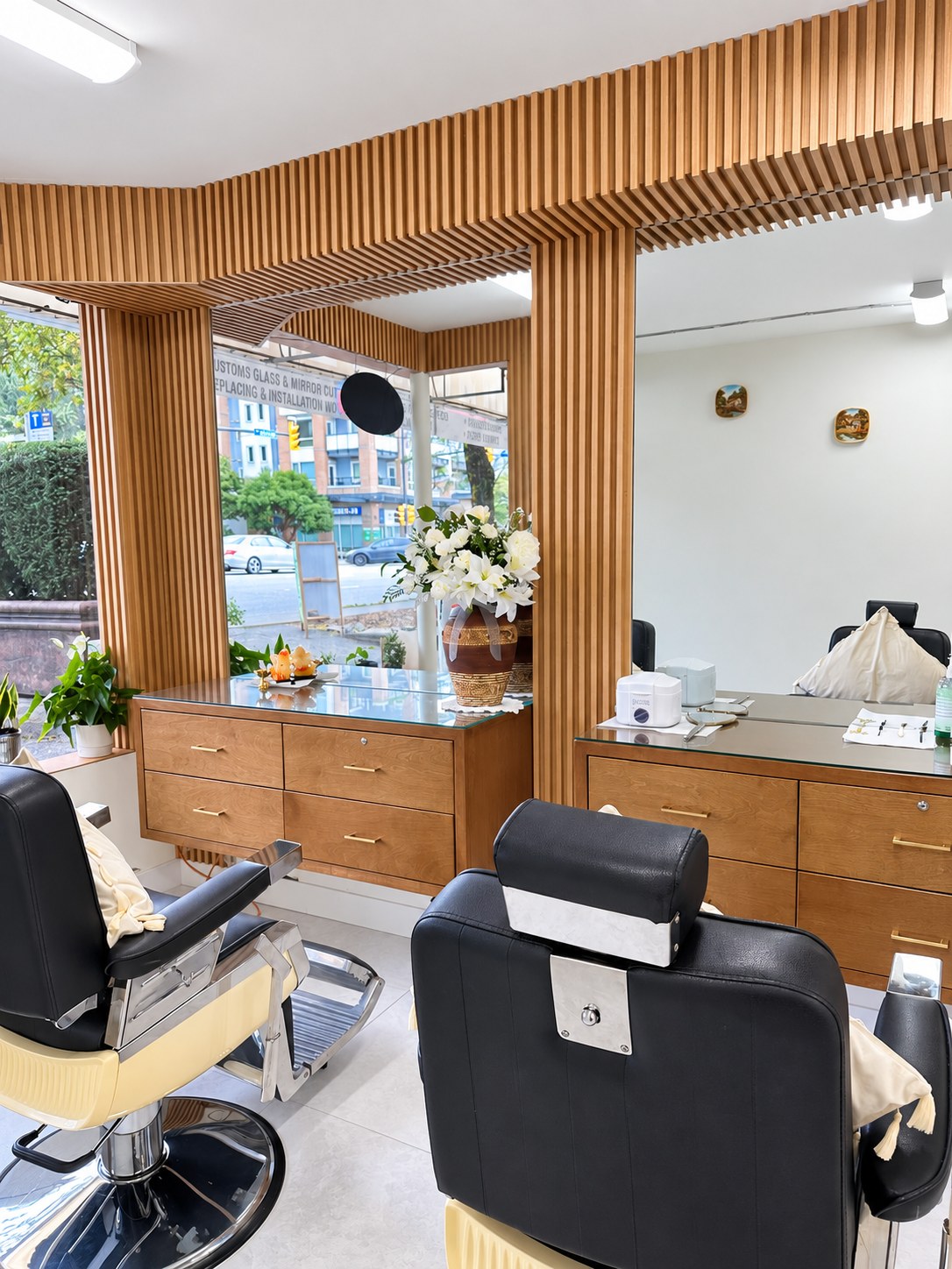 Brow styling chairs, wood framed mirrors and flowers inside HN Brow Bar